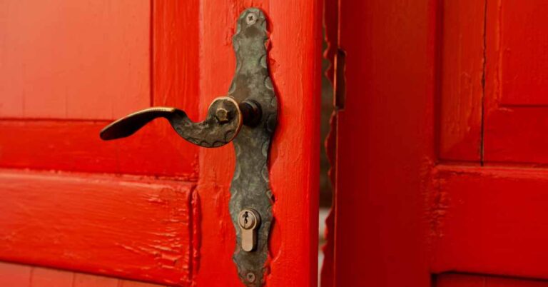 red wooden door possibly sticking